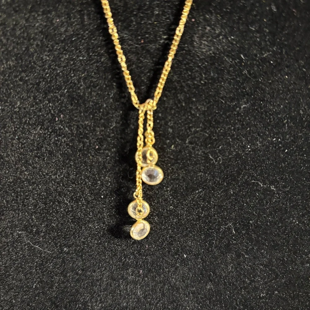 Avon bezeled rhinestone gold toned necklace. 4 stones. Stamped “Avon”. 18”‎